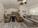 Relaxing living room with reclining chairs, sofa, and ceiling fan at 4352 Adelaide Ave, North Port, FL 34288