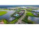 Aerial view of community with lake, pool, and clubhouse at 4517 Mondrian Ct, Sarasota, FL 34240