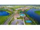 Aerial view of community with lake, pool, and playground at 4517 Mondrian Ct, Sarasota, FL 34240