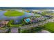 Aerial view of community with lake, pool, and clubhouse at 4517 Mondrian Ct, Sarasota, FL 34240
