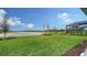 Landscaped backyard with pond views and screened-in patio at 4517 Mondrian Ct, Sarasota, FL 34240