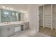 Elegant bathroom with double vanity, walk-in shower, and large closet at 4517 Mondrian Ct, Sarasota, FL 34240