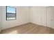 Simple bedroom with wood flooring and a window at 4517 Mondrian Ct, Sarasota, FL 34240
