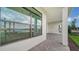 Covered patio with window showcasing a lake view and access to backyard at 4517 Mondrian Ct, Sarasota, FL 34240