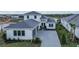 Two-story home with gray roof and paver driveway at 4517 Mondrian Ct, Sarasota, FL 34240