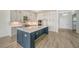 Modern kitchen with a large island and white cabinets at 4517 Mondrian Ct, Sarasota, FL 34240