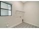 Laundry room with tile flooring and shelving at 4517 Mondrian Ct, Sarasota, FL 34240