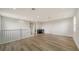 Loft with hardwood floors, wet bar, and a view of the staircase at 4517 Mondrian Ct, Sarasota, FL 34240
