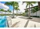 Community pool area with lounge chairs and palm trees at 4517 Mondrian Ct, Sarasota, FL 34240