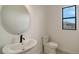 Modern powder room with pedestal sink, toilet, and patterned floor at 4517 Mondrian Ct, Sarasota, FL 34240