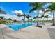 Resort-style pool with ample lounge chairs and palm trees at 4517 Mondrian Ct, Sarasota, FL 34240