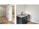Dark-stained wet bar with quartz countertop and mini-fridge at 4517 Mondrian Ct, Sarasota, FL 34240
