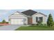 Gray one-story house with a two-car garage and landscaping at 4519 Boxelder Avenue, Parrish, FL 34219