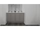 Double vanity bathroom with gray cabinets and dark floors at 4523 Boxelder Avenue, Parrish, FL 34219