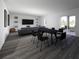 Open concept living and dining area with dark hardwood floors at 4523 Boxelder Avenue, Parrish, FL 34219