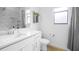 Modern bathroom with white cabinets and marble shower at 4814 Sparkling Sea Ln, Lakewood Ranch, FL 34211