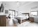 Main bedroom with king bed, access to patio and exercise bike at 4814 Sparkling Sea Ln, Lakewood Ranch, FL 34211