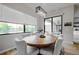 Round dining table with six chairs, located near sliding glass doors at 4814 Sparkling Sea Ln, Lakewood Ranch, FL 34211