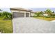 Large paver driveway leading to a three car garage at 4814 Sparkling Sea Ln, Lakewood Ranch, FL 34211
