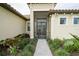 Front entrance with a screened porch and landscaped walkway at 4814 Sparkling Sea Ln, Lakewood Ranch, FL 34211