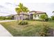 House exterior with palm trees, landscaping, and paver driveway at 4814 Sparkling Sea Ln, Lakewood Ranch, FL 34211