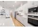 Modern kitchen with white cabinets, gas cooktop and stainless steel appliances at 4814 Sparkling Sea Ln, Lakewood Ranch, FL 34211