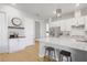 White kitchen cabinets, island with seating, and coffee bar at 4814 Sparkling Sea Ln, Lakewood Ranch, FL 34211