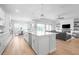 Open concept kitchen with island, stainless steel appliances, and view to living room at 4814 Sparkling Sea Ln, Lakewood Ranch, FL 34211