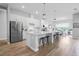 Modern kitchen with white cabinets, large island, and stainless steel appliances at 4814 Sparkling Sea Ln, Lakewood Ranch, FL 34211