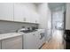 Bright laundry room with white cabinets and washer/dryer at 4814 Sparkling Sea Ln, Lakewood Ranch, FL 34211