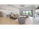 Open living room with leather couches, large windows, and kitchen views at 4814 Sparkling Sea Ln, Lakewood Ranch, FL 34211