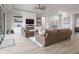 Living room with fireplace, built-in shelving, and sliding doors at 4814 Sparkling Sea Ln, Lakewood Ranch, FL 34211