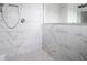 Elegant shower with marble tile and a hexagonal floor at 4814 Sparkling Sea Ln, Lakewood Ranch, FL 34211