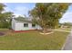 Single story home with a large tree in the front yard at 5195 Brophy St, North Port, FL 34287