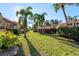 Pathway through green lawn with tropical landscaping at 5343 Huntingwood Ct # 33, Sarasota, FL 34235