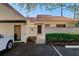 Front view of the home showing landscaping and a carport at 5343 Huntingwood Ct # 33, Sarasota, FL 34235
