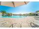 Relaxing pool area with lounge chairs and patio umbrellas at 5684 Palmer Cir # 202, Bradenton, FL 34211