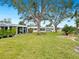 Spacious backyard with lush grass and a shaded sitting area at 5940 Driftwood Ave # 15, Sarasota, FL 34231