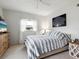 Comfortable bedroom with striped bedding and coastal decor at 5940 Driftwood Ave # 15, Sarasota, FL 34231