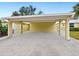 Carport with white columns and a concrete driveway at 5940 Driftwood Ave # 15, Sarasota, FL 34231