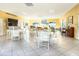 Bright and airy community room with tables, chairs, and a piano at 5940 Driftwood Ave # 15, Sarasota, FL 34231