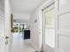Bright entryway with tile floors and view to kitchen at 5940 Driftwood Ave # 15, Sarasota, FL 34231