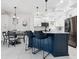 Modern kitchen with a blue island and white cabinets at 5940 Driftwood Ave # 15, Sarasota, FL 34231
