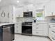 Modern kitchen featuring white cabinets and stainless steel appliances at 5940 Driftwood Ave # 15, Sarasota, FL 34231