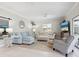 Living room with light blue sectional sofa and view to patio at 5940 Driftwood Ave # 15, Sarasota, FL 34231