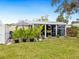 Private patio area with seating, grill, and lush tropical plants at 5940 Driftwood Ave # 15, Sarasota, FL 34231