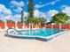 Inviting community pool with lounge chairs and a surrounding fence at 5940 Driftwood Ave # 15, Sarasota, FL 34231