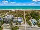 Aerial view of beachfront property with ocean access, showing multiple buildings and lush landscaping at 600/602 Beach Rd # 1 & 2, Sarasota, FL 34242