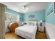 Cozy bedroom with a queen-size bed and light blue walls at 600/602 Beach Rd # 1 & 2, Sarasota, FL 34242