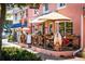 Outdoor seating at a cafe with umbrellas and patrons at 600/602 Beach Rd # 1 & 2, Sarasota, FL 34242